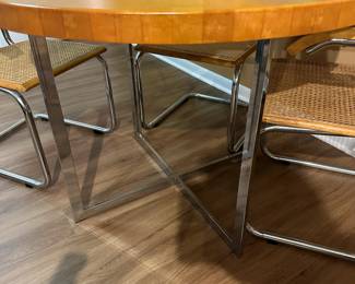 Mid century Cesca style chrome and wood table with chrome and cane chairs. Measures 30" H x 42" diameter. Chairs measure 32"tall at back x 23" widest point. Image 4. Price $850.