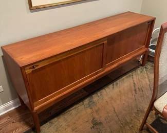 1970's Modernist Teak Sideboard on Base with Sliding Doors. Measures 31"H x 75"L x 18"D. Image 1. Price $850