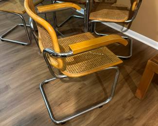 Mid century Cesca style chrome and wood table with chrome and cane chairs. Measures 30" H x 42" diameter. Chairs measure 32"tall at back x 23" widest point. Image 5. Price $850.