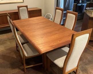 Mid century modernist teak dining room table with chairs, includes an extra leaf (not pictured)