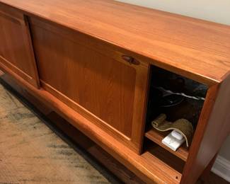 1970's Modernist Teak Sideboard on Base with Sliding Doors. Measures 31"H x 75"L x 18"D. Image 7. Price $850