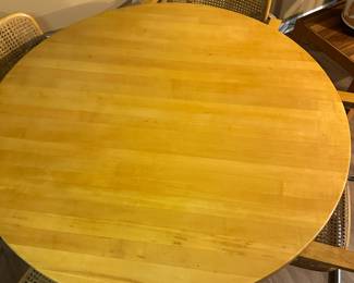 Mid century Cesca style chrome and wood table with chrome and cane chairs. Measures 30" H x 42" diameter. Chairs measure 32"tall at back x 23" widest point. Image 2. Price $850.