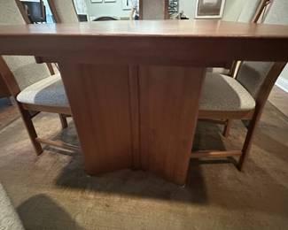 1970's Modernist Teak Dining Room Table with 6 Chairs. Includes extra leaf (not shown). Measurements as shown: 31"H x 38"W x 70"L. Chairs measure 42" tall to the top of the back x 19"W at widest point of seat. Image 9. Table and 6 Chairs $2400.
