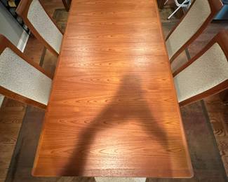 1970's Modernist Teak Dining Room Table with 6 Chairs. Includes extra leaf (not shown). Measurements as shown: 31"H x 38"W x 70"L. Chairs measure 42" tall to the top of the back x 19"W at widest point of seat. Image 6. Table and 6 Chairs $2400.