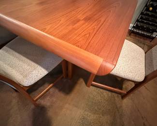 1970's Modernist Teak Dining Room Table with 6 Chairs. Includes extra leaf (not shown). Measurements as shown: 31"H x 38"W x 70"L. Chairs measure 42" tall to the top of the back x 19"W at widest point of seat. Image 8. Table and 6 Chairs $2400.