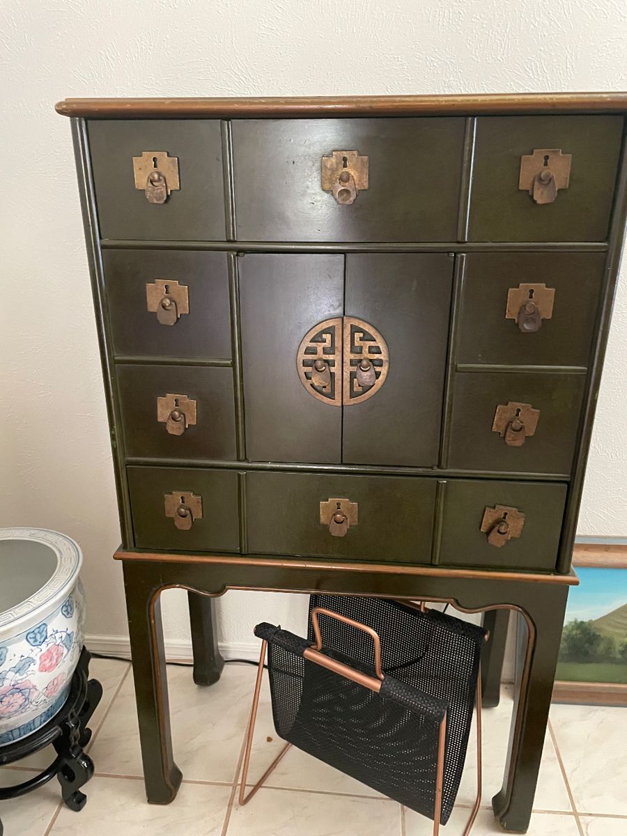Vintage Chinese Storage Cabinet Upper & Lower Drawers and Storage behind Center Doors. Brass detailing on dark Green cabinet.