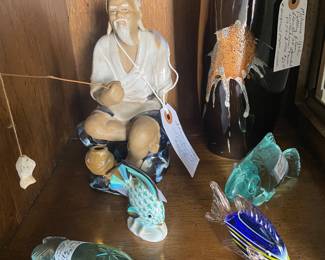 Mudman with fishing pole, glass & porcelain fish and Japanese vase. 