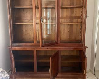 Shows lower storage behind solid doors. 
