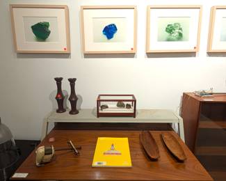 Series of photographs, midcentury modern desk, and various collectibles