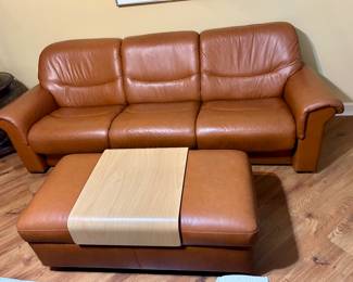 Stressless leather dual reclining sofa with storage ottoman and removable wooden tray