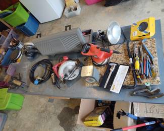Bench with vice, several handheld tools, chisels and crowbars