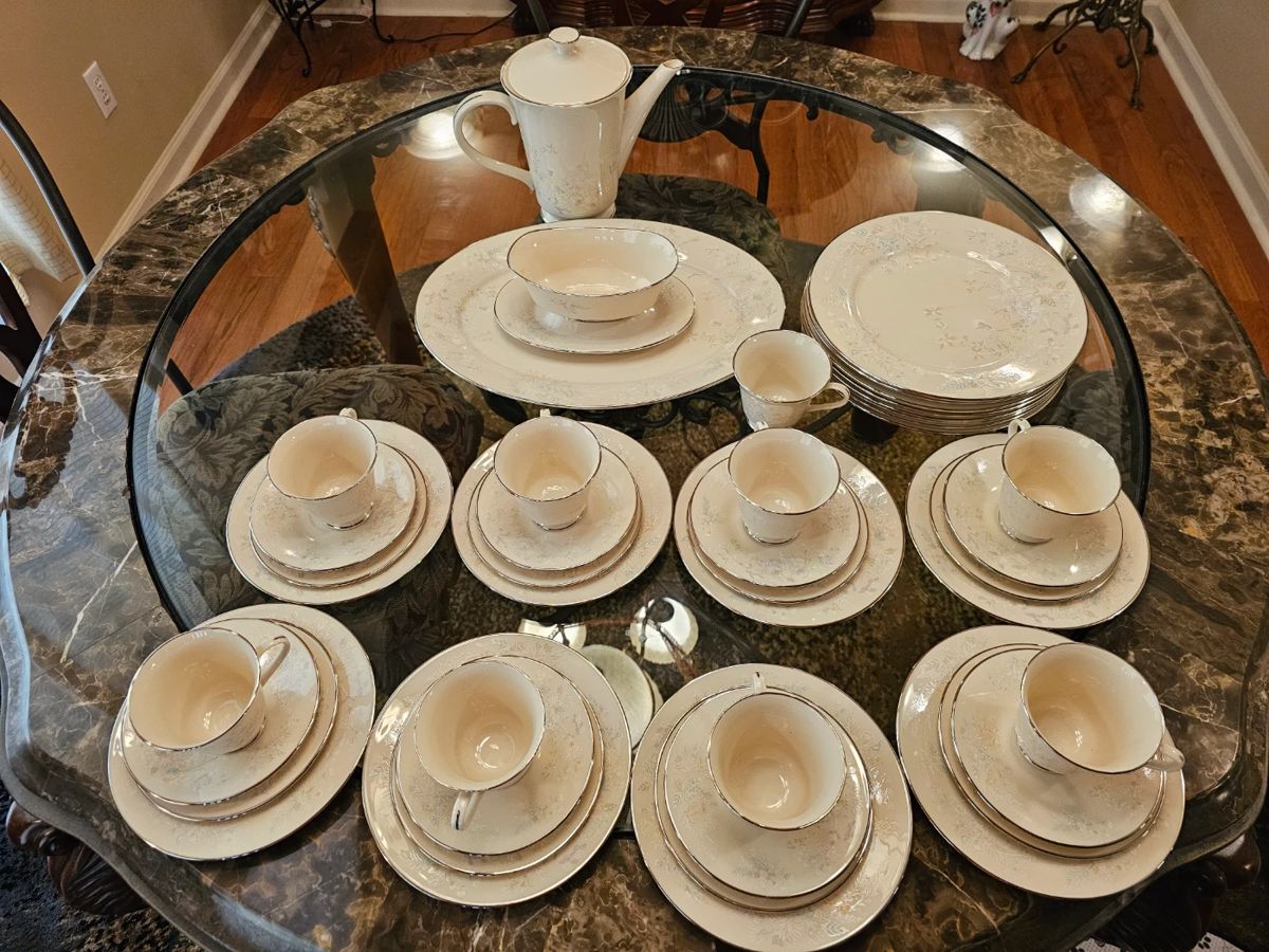 Elevate your dining experience with the LENOX APRIL 43pc SERVICE for EIGHT. All pieces are in excellent condition.  Bone china pieces showcase a glossy finish and a multicolor floral pattern that brings a touch of elegance to your table. This service set includes 8 dinner plates, 8 bread plates, 8 salad plates, 8 coffee cups & saucers (+ 1 cup), large platter, gravy boat and coffee pot.  This original set is a testament to LENOX's commitment to quality and style.
