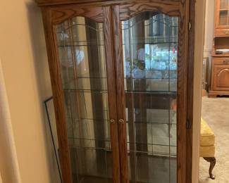large curio cabinet with glass doors & mirrored back panel