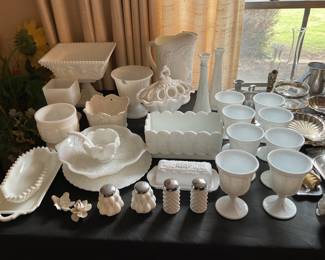  Extensive collection of vintage milk glass featuring a beautiful assortment of bowls, goblets, compotes, vases, serving dishes, and salt and pepper shakers