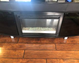 90” black fireplace with surround sound & was used to hold 85” TV $200