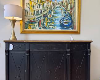 (SOLD; large format original art on canvas with linen mat and gold frame; 64x47) ($800; Hooker Furniture Sanctuary line 4-door, 3-drawer credenza with distressed black finish on base and wood tone on top; in excellent condition; 77x21x51) ($60; hammered gold tone and acrylic table lamp; 32x16