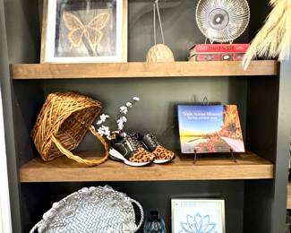 ($28; butterfly artwork; top left) ($48; wood and metal bird sculptue; top center) ($12; silver etched bowl; top right) ($50; vintage Lenox tray with grape vine motif; bottom left) ($8; bliss frame; bottom center) ($18; blue bubble vase: bottom center) ($12; silver framed art; bottom right)