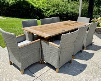 $600; outdoor teak wood table with 8 resin wicker and wood chairs plus seat cushions; wood is weathered, wicker on chairs in great condition; table: 89x40x30; chairs: 25x21x26