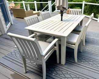 ($600; hand-painted Pottery Barn outdoor wood extension table--pops out of the middle-- 2 arm chairs and 4 side chairs with cushions, cover included: table: 74x40x30; arm chairs: 24x26x36; side chairs: 19x26x36) (Sunvilla umbrella with outdoor linen-type fabric and tilt feature, plus floral metal stand; 9'd) ($60; indoor/outdoor rug; 8'x10')