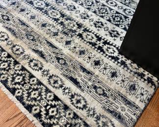 $100; Safavieh ivory and black rug with geometric design; HOLE cut in it for outlet access; approximately 8'x10'
