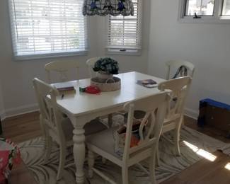 Dining set seats 6; faux Tiffany light fixture; area rug