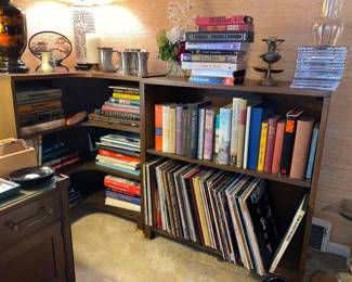 Multiple MCM bookshelves packed full of various books and decor