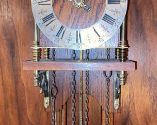 Antique clock with brass weights