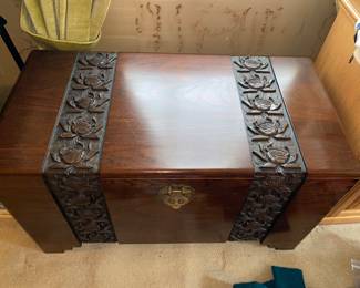 Carved wood chest with intricate rose designs