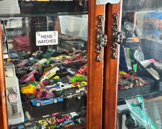 Cabinet of Mens and Womens Watches. Cabinet houses out of the packaging variety of Hot Wheels Models all priced individually. China Cabinet by itself without the contents pictured is available for purchase.