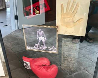 Large shadow of Muhammad Ali memorabilia. 27" wide, 7.5" deep, 32" tall.
