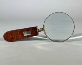 Sterling Silver Mounted Leather Handle Magnifying Glass | Marked Sterling on the mount, with a maker's mark "B", on a crocodile embossed leather handle
Dimensions: h. 8.5 x w. 3.5 x d. .5 x dia. 3.5 in