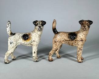 (2pc) Hubley cast iron fox terriers | Metal painted dog door stops by Hubley. - h. 8.5 x w. 4 x l. 8 in (Whiter of the two.)