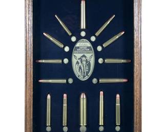 Tatonka Cartridge Shadowbox, Cabela’s Safari Collection | Big Game / African Safari Archives - framed collection of Tatonka Cartridge bullets for big game hunting. Mounted on a black mat in a display case frame. - h. 19.5 x w. 15.5 x d. 2 in