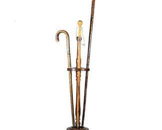 (4pc) Three Wooden Walking Sticks & Wood Cane or Pool Cue Holder | Includes One Alpine Badge Hiking Stick 34' Long 5' Wide . 1 Carved Woodcock Head Long Walking Stick with Glass Eyes 50' Long 4' Wide
One Plain Hiking Stick 37' Long.