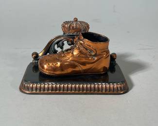 Bronzed Child’s Shoe | Sitting on shelf with crown on the back. Numbered on the inside. - h. 4 x w. 3.5 x l. 7 in
