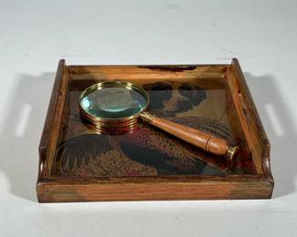 (2pc) Vintage Glass & Wood Pheasant Spaniel Tray With Wood & Brass Magnifying Glass | Vintage wood and glass hunting scene tray with handles plus a wood and brass magnifying glass Tray measures 10.5’ x 10.5’ Magnifying glass measures 10’ long 4’ wide
Dimensions: h. 2.5 x w. 10.5 x l. 10.5 in (tray)