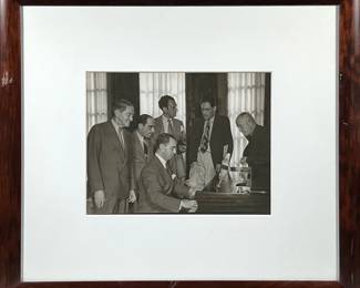 Richard Rogers At The Piano Photograph | Richard Rodgers at the piano, surrounded by, among others, Lorenz Hart, Moss Hart and George S. Kaufman. black and white with dark brown frame. 10.5” h x 13.5” w sight - h. 23 x l. 26 in (Frame)
