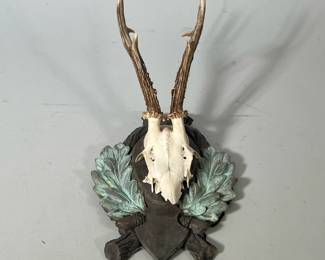 Hunting Trophy | Mounted roe deer trophy features the skull and antlers of a deer mounted on a decorative, carved piece of plaster. - h. 12 x w. 8 x d. 8 in