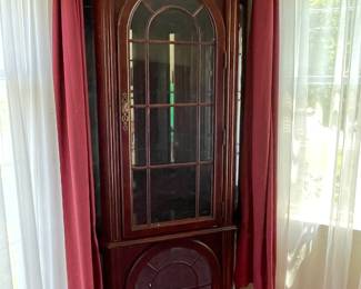 Queen Anne curio cabinet — top abs bottom sections have lighting 