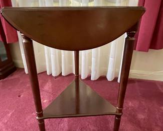Queen Anne triangular table with folding leaves at ends. 