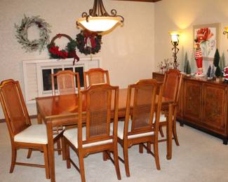A 1970s Henry Link "Mandarin" dining room set which includes a rectangle table with two 18" leaves; one Captain chair and 5 side chairs, a double cabinet sideboard/buffet and a China cabinet with detailed fretwork.