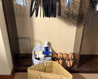 Includes assorted hangers, two fabric storage bins, a bottle of wrinkle releaser, and shoe trees for keeping footwear in shape. Ideal for home organization.
