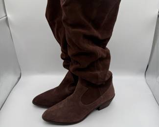 Anthropologie Brown Suede Knee-High Slouch Boots with Low Heels - Size 8.5 M. Brown suede knee-high slouch boots with a pointed toe and a low heel. The boots feature a soft, wrinkled texture and a side cut-out design. The soles are black with a textured finish.