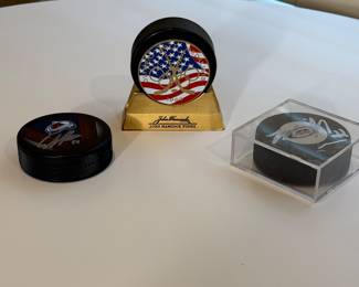 This is a collection of autographed hockey pucks including the special 1980 US Olympic Team know for having won against Russia, signed by Jim Craig. 
