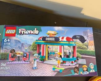 Description:
Includes LEGO Friends set 41728 featuring bright colors and playful design, LEGO Creator 3-in-1 set 31113 with a colorful camper van and beach houses, and a red and yellow circular game container labeled 'Spot it!' with an eye-catching logo.
