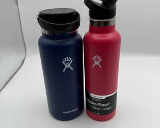 Hydro Flask Water Bottles - Set of 2. Includes 1 navy blue and 1 pink bottle. Durable, insulated design for keeping drinks hot or cold. New Condition.