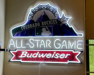 This is a collection of memorabilia from the 2021 season when Denver hosted the MLB All-Star game. Collection includes a lighted sign, poster and Louisville Slugger bat. 