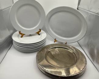 This set includes eight white dinner plates, featuring a beaded rim design, and one larger oval platter. The dinner plates are smooth and plain, showing a pristine white color and round shape. The oval platter has a similar design with a silver accent bordering the edge, complementing the white finish. The pieces are made of ceramic material and are suitable for formal dining settings. Also included are eight high quality metal charger plates with a similar beaded design. Perfect for upgrading the look of your table every day or for special occasions.&nbsp;