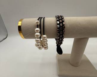 Beautiful freshwater pearl bracelet featuring three strand and a button closure. Bracelet is in very good condition and is a fun statement piece. Also included is a fun beaded bracelet with multi color metal beads.