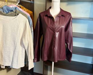 This is a large lot high fashion shirts and blouses including vegan leather top shirt, thermal with a ruffle back, a shirred velvet tunic from Free People, and a sweatshirt with a fun bow on the back. Stylish and trendy, perfect for various occasions. See pictures for more details.